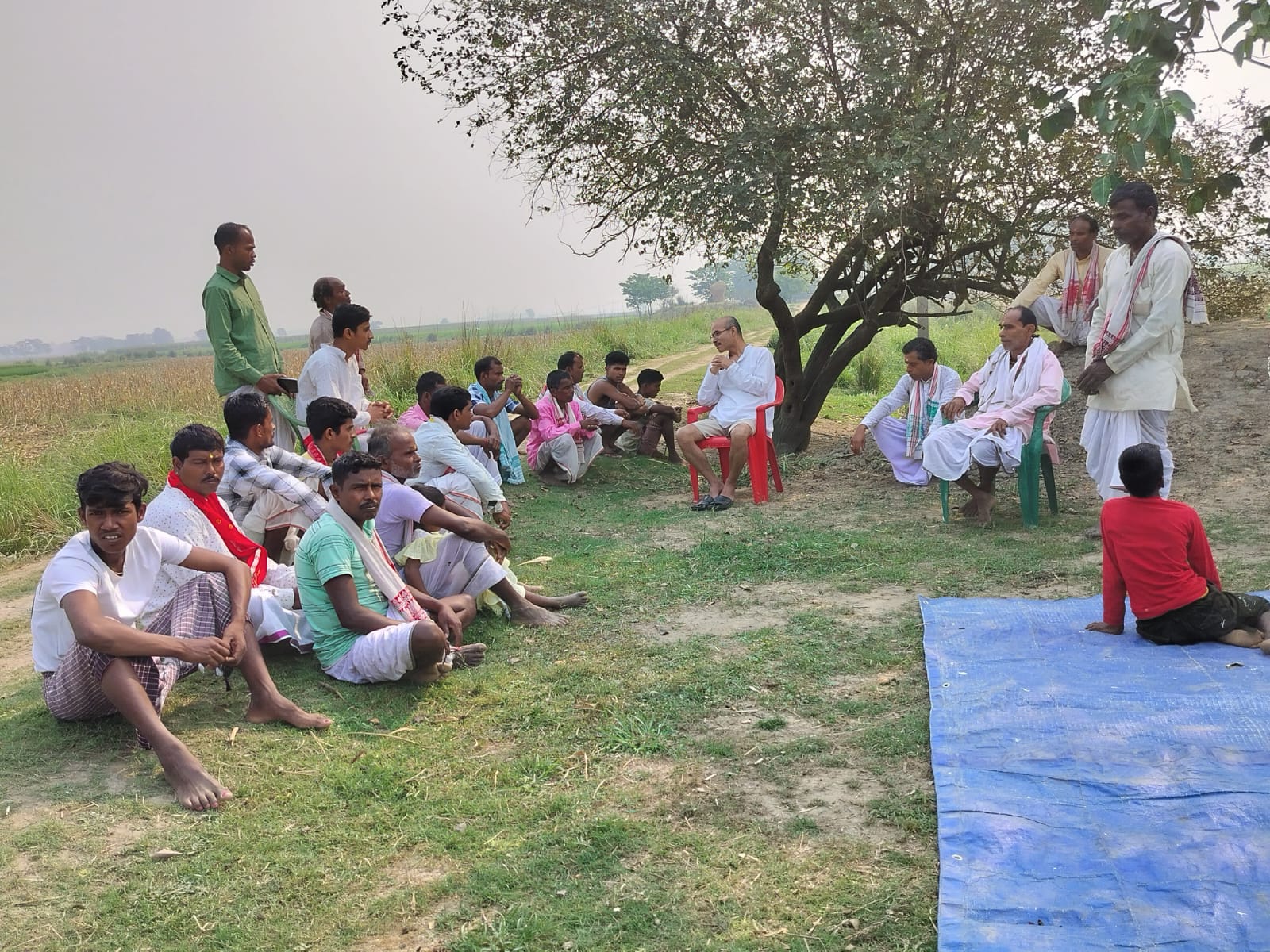 Community discussion with farmers under a tree