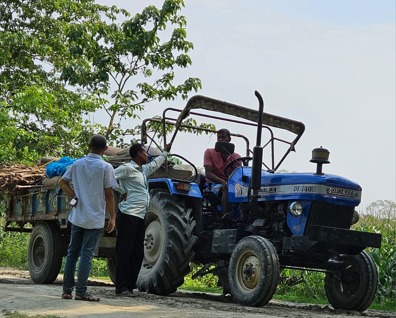 Team coordinating with a farmer on a tractor